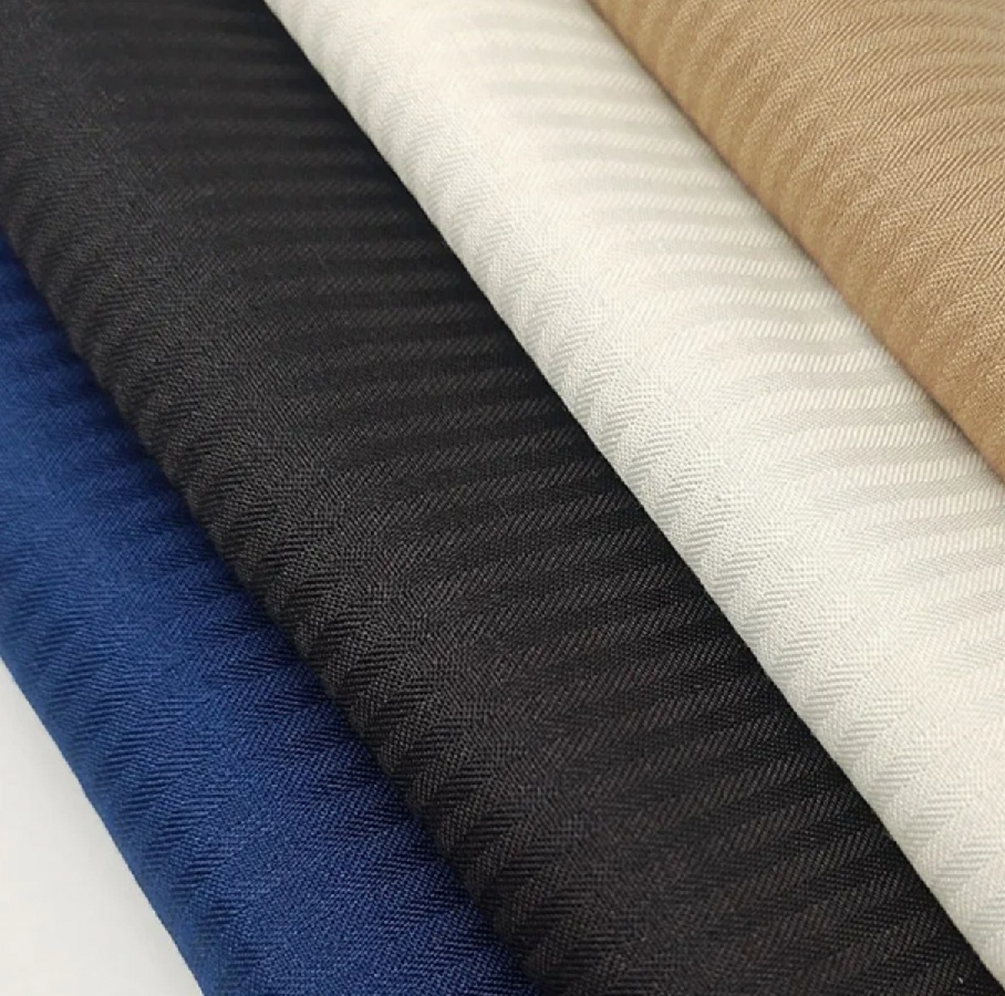 Blue, black, white and beige lining and pocketing fabrics showing woven texture